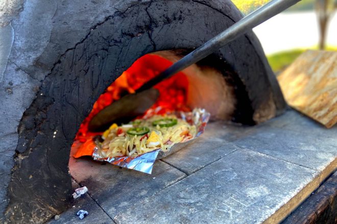Experience local cuisine and stone oven pizza baking