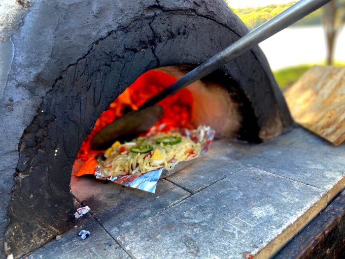 Experience local cuisine and stone oven pizza baking